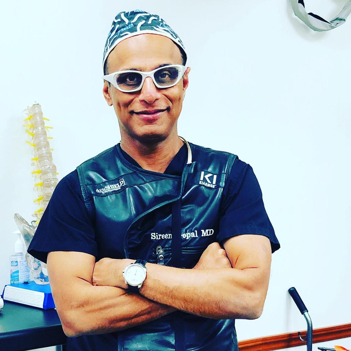Dr. Sireen Gopal in a lead apron with an anatomical spine model